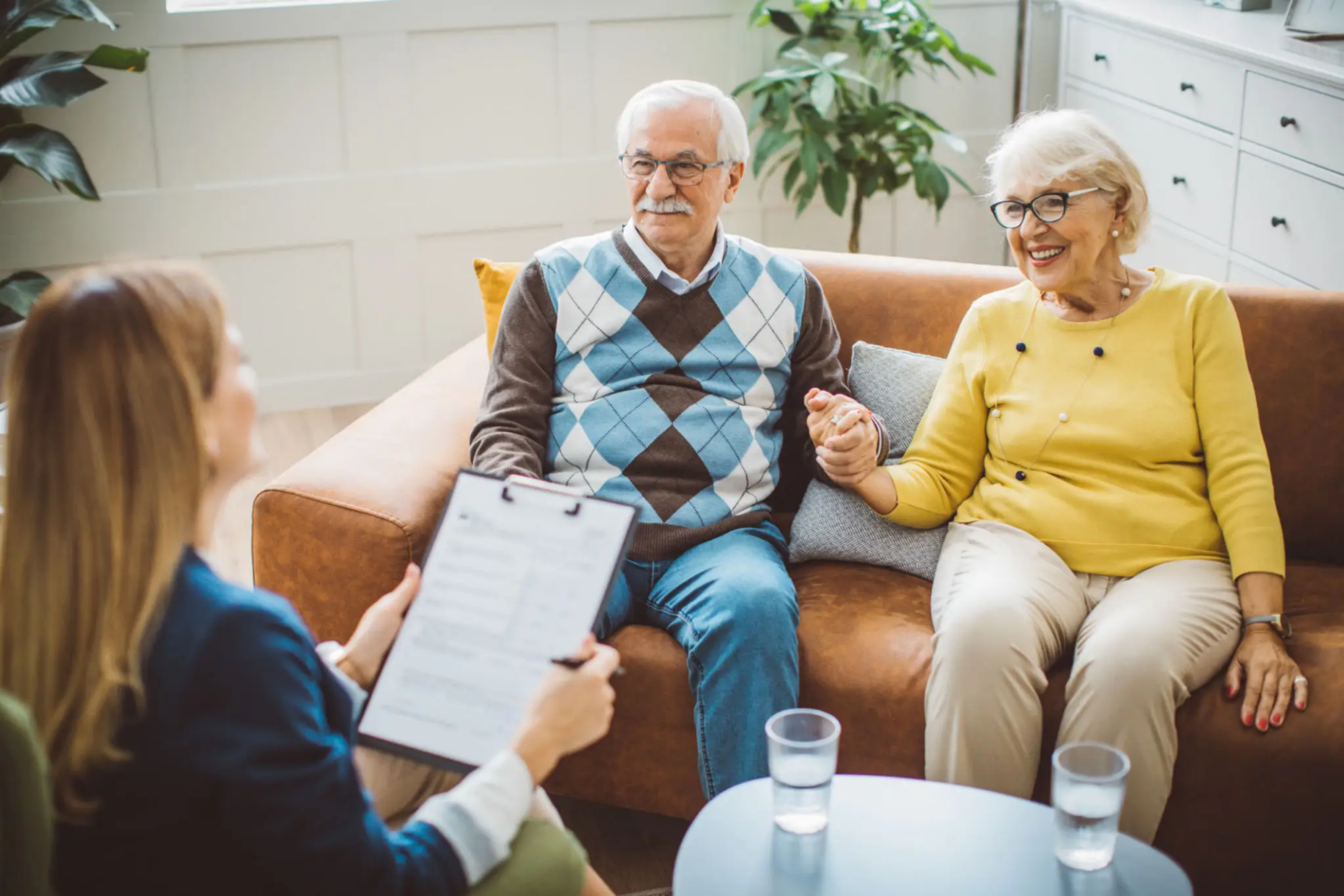 Senior couple holding hands during a counseling session.